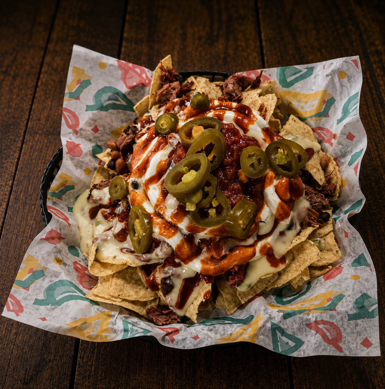Brisket nachos with queso, jalapenos, salsa and BBQ sauce