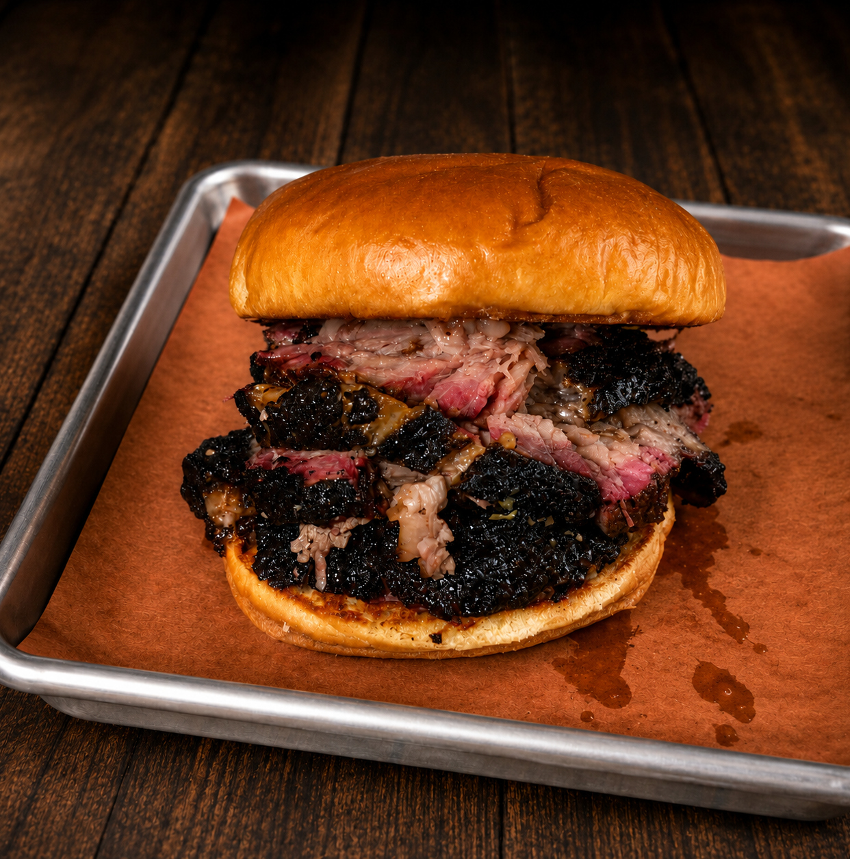 Half pound smoked brisket sandwich with pickles and pickled onions